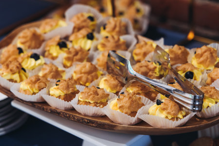 Catering table, beautifully decorated banquet with variety of different food snacks appetizers on Christmas birthday corporate party event or wedding celebration, canape, salad, delicatessen settingの写真素材