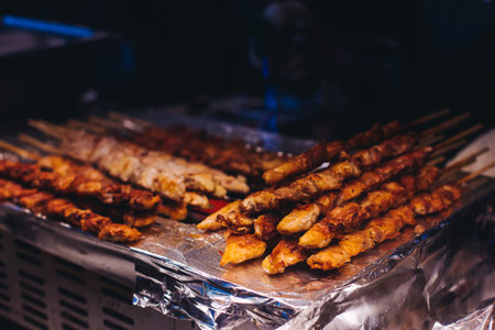Korean barbecue, Ddakkochi, grilled chicken and pork skewers, variety of different traditional street food selection in Seoul, South Korea, market with local vendor stalls cooking tasty dishesの写真素材