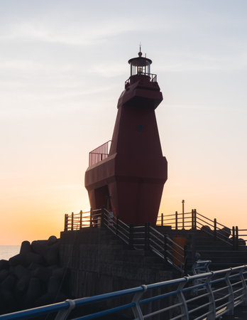 Iho Tewoo Horse Lighthouses on Iho Tewoo beach, with two horse-shaped lighthouses, white horse lighthouse and red horse lighthouse, Jeju-do, Jeju island, Jeju-si, South Korea, sunny sunsetの写真素材