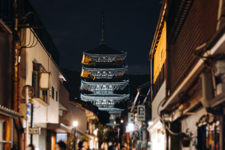 View of Gion district street, Kyoto, Higashiyama-ku, Japan, night illumination of Ninnenzaka and Sannenzaka streets, with old wooden tea houses Hokanji temple and Yasaka Pagoda, Gion geisha quarterの写真素材