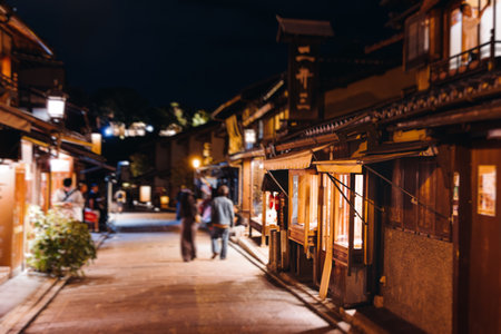 View of Gion district street, Kyoto, Higashiyama-ku, Japan, night illumination of Ninnenzaka and Sannenzaka streets, with old wooden tea houses Hokanji temple and Yasaka Pagoda, Gion geisha quarterの写真素材