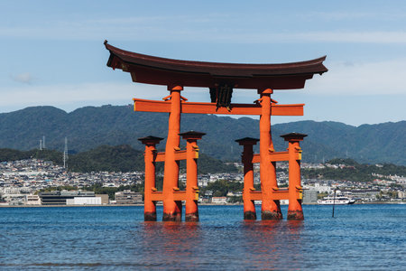 Itsukushima Shrine landscape view, Grand Torii floating gate, Japan, Hiroshima prefecture, Miyajima island panorama, Japan in a summer sunny day (Text on the gate - Itsukushima Shrine), Shinto shrineの写真素材