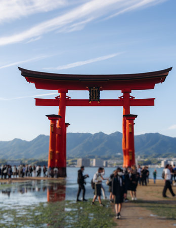 Itsukushima Shrine landscape view, Grand Torii floating gate, Japan, Hiroshima prefecture, Miyajima island panorama, Japan in a summer sunny day (Text on the gate - Itsukushima Shrine), Shinto shrineの写真素材