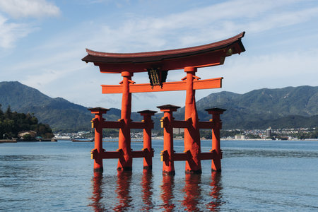 Itsukushima Shrine landscape view, Grand Torii floating gate, Japan, Hiroshima prefecture, Miyajima island panorama, Japan in a summer sunny day (Text on the gate - Itsukushima Shrine), Shinto shrineの写真素材