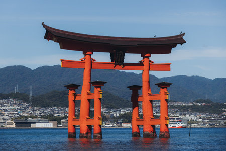 Itsukushima Shrine landscape view, Grand Torii floating gate, Japan, Hiroshima prefecture, Miyajima island panorama, Japan in a summer sunny day (Text on the gate - Itsukushima Shrine), Shinto shrineの写真素材