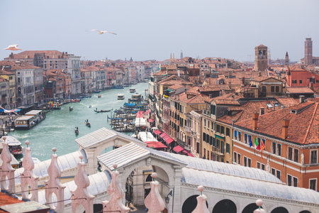 Venice panorama, Veneto, Italy, beautiful aerial panoramic view of Venetian Grand Channel Canal with gondolas, rooftops, skyline and scenery beyond the city, in a summer sunny day, travel to Veneziaの写真素材
