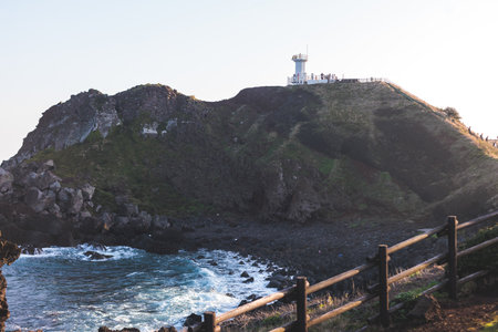 Jeju-do, Seopjikoji cape landscape with lighthouse and sea, east coast of Jeju Island, South Korea, Seongsan-ri, Seogwipo, Jeju Province view in a sunny day, with sea and cliffsの写真素材