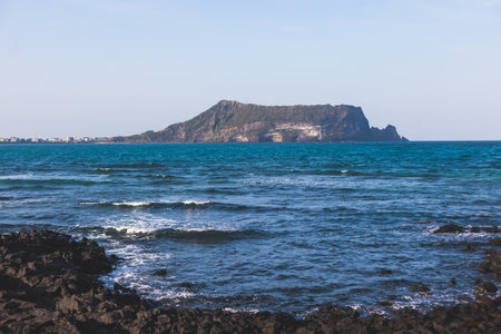 Jeju-do, Seongsan Ilchulbong landscape, volcanic tuff cone, Sunrise peak, Jeju Island, South Korea, Seongsan-ri, Seogwipo, Jeju Province landscape view in a sunny day, with sea, cliffs hiking trailの写真素材