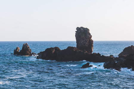 Jeju-do, Seopjikoji cape landscape with lighthouse and sea, east coast of Jeju Island, South Korea, Seongsan-ri, Seogwipo, Jeju Province view in a sunny day, with sea and cliffsの写真素材