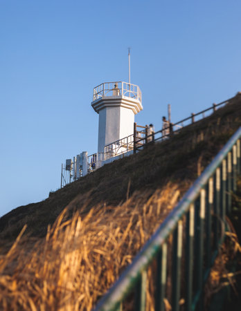 Jeju-do, Seopjikoji cape landscape with lighthouse and sea, east coast of Jeju Island, South Korea, Seongsan-ri, Seogwipo, Jeju Province view in a sunny day, with sea and cliffsの写真素材