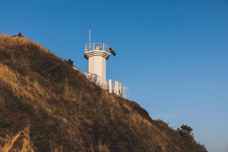 Jeju-do, Seopjikoji cape landscape with lighthouse and sea, east coast of Jeju Island, South Korea, Seongsan-ri, Seogwipo, Jeju Province view in a sunny day, with sea and cliffsの写真素材