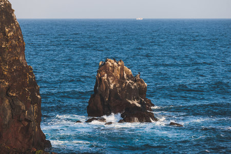 Jeju-do, Seopjikoji cape landscape with lighthouse and sea, east coast of Jeju Island, South Korea, Seongsan-ri, Seogwipo, Jeju Province view in a sunny day, with sea and cliffsの写真素材