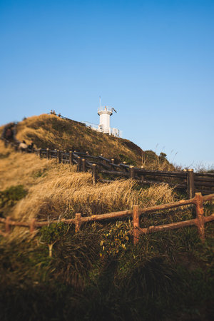 Jeju-do, Seopjikoji cape landscape with lighthouse and sea, east coast of Jeju Island, South Korea, Seongsan-ri, Seogwipo, Jeju Province view in a sunny day, with sea and cliffsの写真素材
