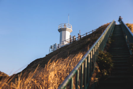 Jeju-do, Seopjikoji cape landscape with lighthouse and sea, east coast of Jeju Island, South Korea, Seongsan-ri, Seogwipo, Jeju Province view in a sunny day, with sea and cliffsの写真素材
