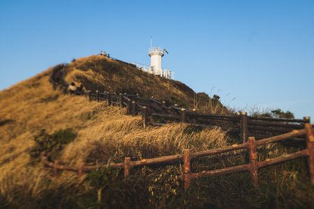 Jeju-do, Seopjikoji cape landscape with lighthouse and sea, east coast of Jeju Island, South Korea, Seongsan-ri, Seogwipo, Jeju Province view in a sunny day, with sea and cliffsの写真素材
