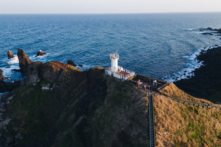Jeju-do, Seopjikoji cape landscape with lighthouse and sea, east coast of Jeju Island, South Korea, Seongsan-ri, Seogwipo, Jeju Province view in a sunny day, with sea and cliffsの写真素材