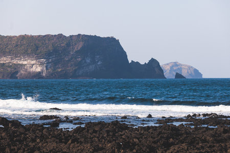 Jeju-do, Seongsan Ilchulbong landscape, volcanic tuff cone, Sunrise peak, Jeju Island, South Korea, Seongsan-ri, Seogwipo, Jeju Province landscape view in a sunny day, with sea, cliffs hiking trailの写真素材