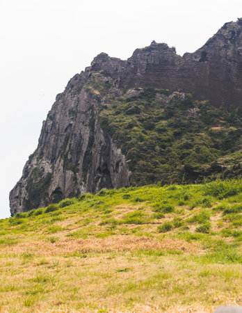 Jeju-do, Seongsan Ilchulbong landscape, volcanic tuff cone, Sunrise peak, Jeju Island, South Korea, Seongsan-ri, Seogwipo, Jeju Province landscape view in a sunny day, with sea, cliffs hiking trailの写真素材