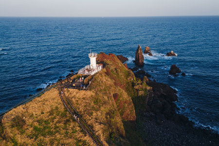 Jeju-do, Seopjikoji cape landscape with lighthouse and sea, east coast of Jeju Island, South Korea, Seongsan-ri, Seogwipo, Jeju Province view in a sunny day, with sea and cliffsの写真素材