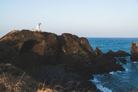 Jeju-do, Seopjikoji cape landscape with lighthouse and sea, east coast of Jeju Island, South Korea, Seongsan-ri, Seogwipo, Jeju Province view in a sunny day, with sea and cliffsの写真素材