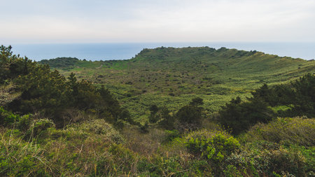 Jeju-do, Seongsan Ilchulbong landscape, volcanic tuff cone, Sunrise peak, Jeju Island, South Korea, Seongsan-ri, Seogwipo, Jeju Province landscape view in a sunny day, with sea, cliffs hiking trailの写真素材