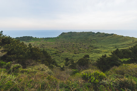 Jeju-do, Seongsan Ilchulbong landscape, volcanic tuff cone, Sunrise peak, Jeju Island, South Korea, Seongsan-ri, Seogwipo, Jeju Province landscape view in a sunny day, with sea, cliffs hiking trailの写真素材