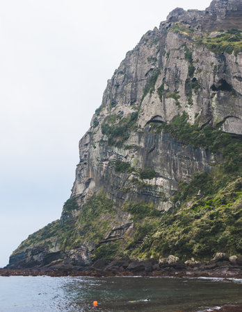 Jeju-do, Seongsan Ilchulbong landscape, volcanic tuff cone, Sunrise peak, Jeju Island, South Korea, Seongsan-ri, Seogwipo, Jeju Province landscape view in a sunny day, with sea, cliffs hiking trailの写真素材