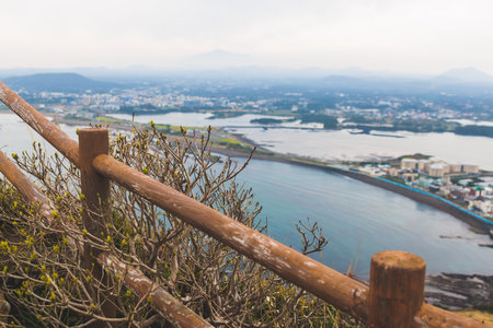Jeju-do, Seongsan Ilchulbong landscape, volcanic tuff cone, Sunrise peak, Jeju Island, South Korea, Seongsan-ri, Seogwipo, Jeju Province landscape view in a sunny day, with sea, cliffs hiking trailの写真素材