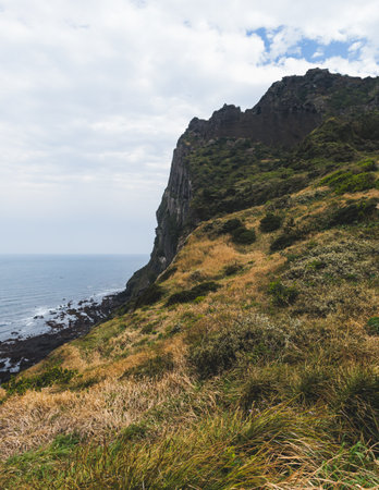 Jeju-do, Seongsan Ilchulbong landscape, volcanic tuff cone, Sunrise peak, Jeju Island, South Korea, Seongsan-ri, Seogwipo, Jeju Province landscape view in a sunny day, with sea, cliffs hiking trailの写真素材