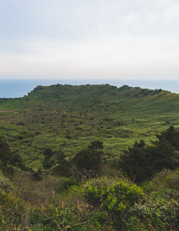 Jeju-do, Seongsan Ilchulbong landscape, volcanic tuff cone, Sunrise peak, Jeju Island, South Korea, Seongsan-ri, Seogwipo, Jeju Province landscape view in a sunny day, with sea, cliffs hiking trailの写真素材