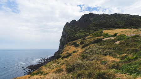 Jeju-do, Seongsan Ilchulbong landscape, volcanic tuff cone, Sunrise peak, Jeju Island, South Korea, Seongsan-ri, Seogwipo, Jeju Province landscape view in a sunny day, with sea, cliffs hiking trailの写真素材