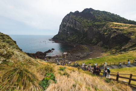 Jeju-do, Seongsan Ilchulbong landscape, volcanic tuff cone, Sunrise peak, Jeju Island, South Korea, Seongsan-ri, Seogwipo, Jeju Province landscape view in a sunny day, with sea, cliffs hiking trailの写真素材