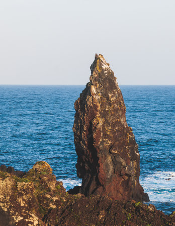 Seopjikoji cape landscape with lighthouse and sea, east coast of Jeju Island, Seongsan-ri, Seogwipo, Jeju Province view in a sunny day, with sea and cliffsの写真素材