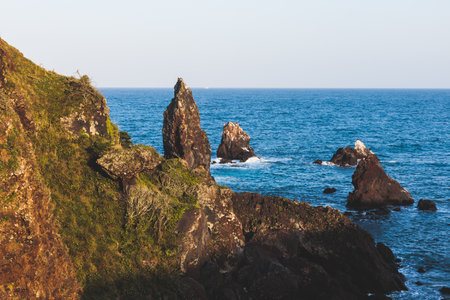Jeju-do, Seopjikoji cape landscape with lighthouse and sea, east coast of Jeju Island, South Korea, Seongsan-ri, Seogwipo, Jeju Province view in a sunny day, with sea and cliffsの写真素材