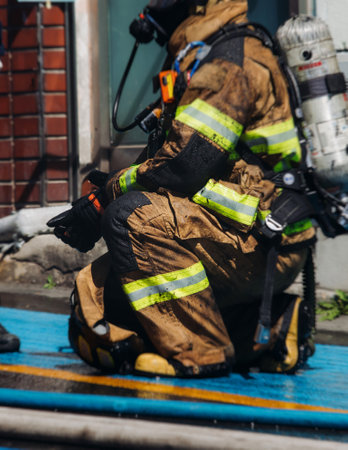 Group of South Korean fire men during fire fighting operation in the streets, firefighters with fire engine truck vehicle, 911 emergency and rescue, fire drill, exercise training, Busan, South Koreaの写真素材
