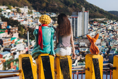 View of Little Prince statue and desert Fox sculpture figure in Gamcheon Culture village, Busan, South Korea, Gamcheon-dong, Saha District, streets and multicolored houses and roofs in a sunny dayの写真素材