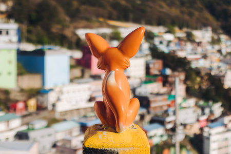 View of desert Fox sculpture figure in Gamcheon Culture village, Busan, South Korea, Gamcheon-dong, Saha District, streets and multicolored houses and roofs in a sunny dayの写真素材