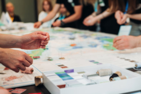 Process of playing tabletop board game on the table, fun with friends and family in room indoors,...