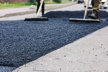 Roadworks, process of asphalting, blacktopping and paving new road layer, laying new asphalt road...