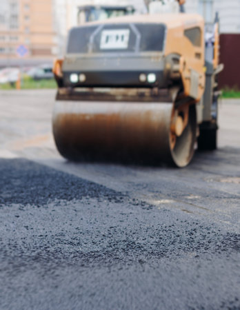 Roadworks, process of asphalting, blacktopping and paving new road layer, laying new asphalt road...