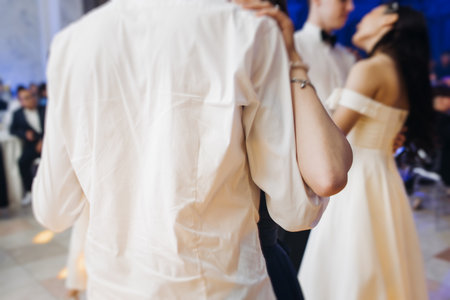 High school graduates dancing on prom, waltz and classical ball slow dance in dresses and suits on school graduation party, boys and girls ballroom dancers, couples dance quadrille, polonaiseの写真素材
