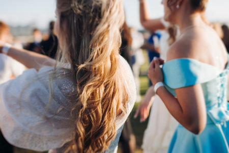 High school graduates dancing on prom, waltz and classical ball slow dance in dresses and suits on school graduation party, boys and girls ballroom dancers, couples dance quadrille, polonaiseの写真素材