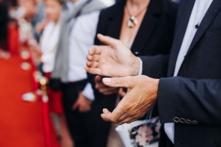 Red carpet with ropes and golden barriers on a luxury party entrance, cinema premiere film festival event award gala ceremony, wealthy rich guests arriving, outdoor decoration elements, summer dayの写真素材