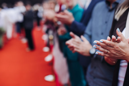 Red carpet with ropes and golden barriers on a luxury party entrance, cinema premiere film festival event award gala ceremony, wealthy rich guests arriving, outdoor decoration elements, summer dayの写真素材