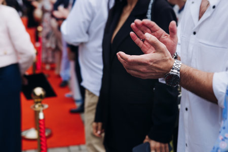 Red carpet with ropes and golden barriers on a luxury party entrance, cinema premiere film festival event award gala ceremony, wealthy rich guests arriving, outdoor decoration elements, summer dayの写真素材
