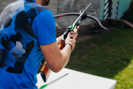 Crossbow shooting and archery at the shooting range, women and men practicing with arbalest at...