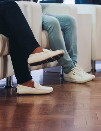 Speakers legs at the business conference event, audience on forum summit, plenary session lecture hall, persons on a stage at plenary meeting, business congress at the venue, panel discussionの写真素材