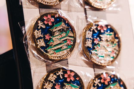 Japanese tourist souvenirs and gifts from Osaka, Kansai, Japan, with figures, key ring keychain magnet refrigerators with Osaka castle, toys figurines, shopping in Japan, presents in a local vendor shopの写真素材