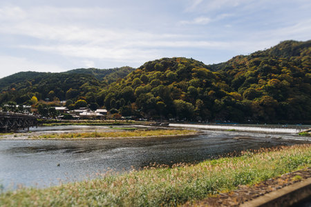 Arashiyama district panorama in western Kyoto, Japan, with boats and mountain, Togetsukyo bridge, Katsura Hozu River, autumn fall landscape view, travel to Japan, Kansai region, Kyotoの写真素材