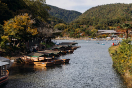 Arashiyama district panorama in western Kyoto, Japan, with boats and mountain Arashi, Togetsukyo bridge, Katsura Hozu River, autumn fall landscape view, travel to Japan, Kansai region, Kyotoの写真素材